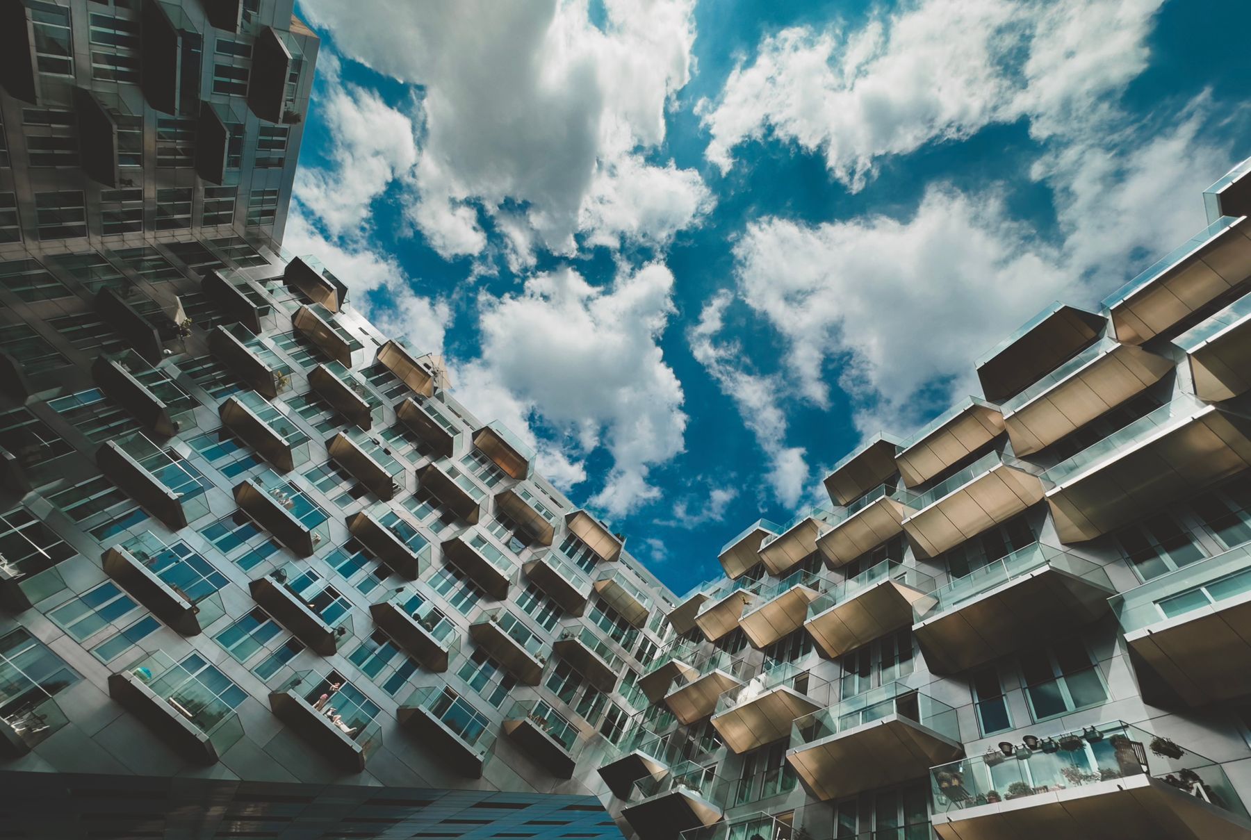 Looking up at the balconies of a modern residential building