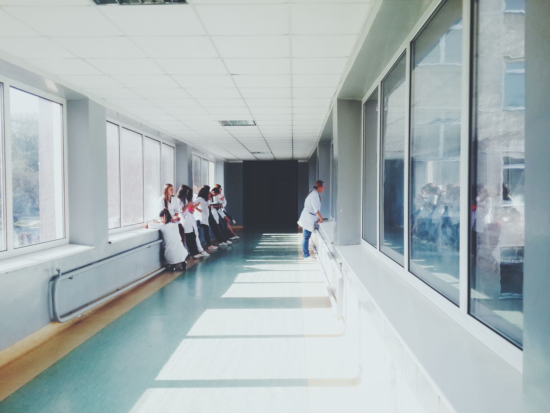 Bright hospital hallway with large windows