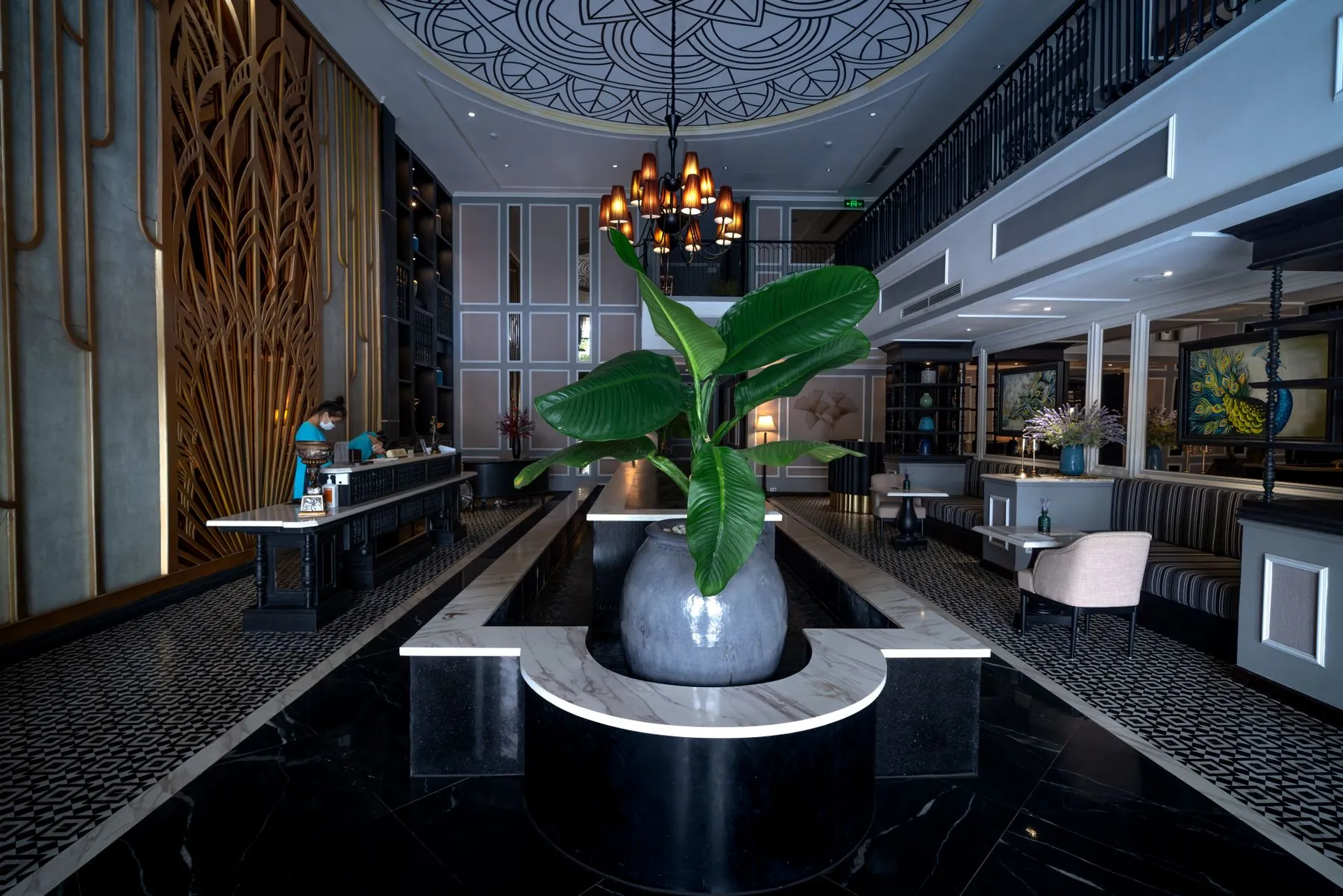 Hotel lobby with marble floors, a chandelier and a reception desk