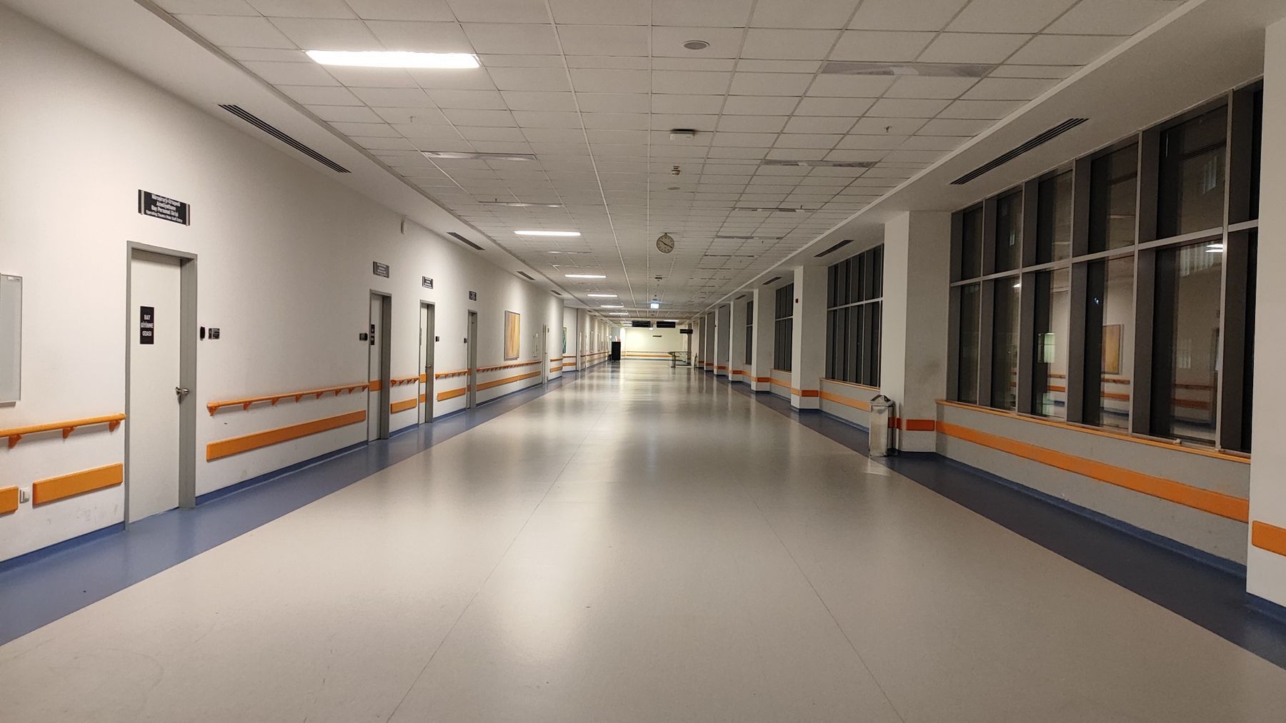 Wide, well-lit corridor in a modern care facility