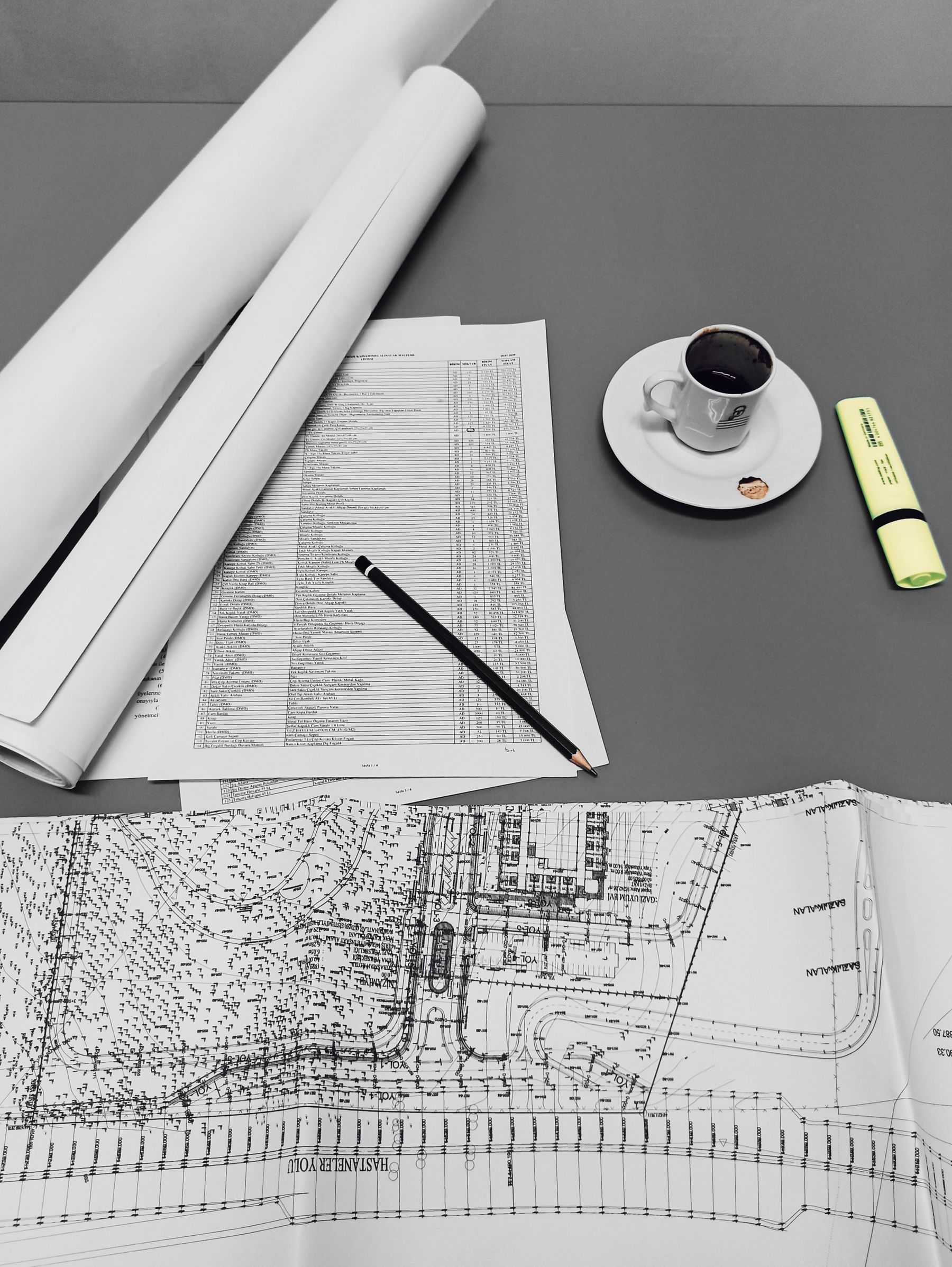 Drawings and a coffee cup on a desk