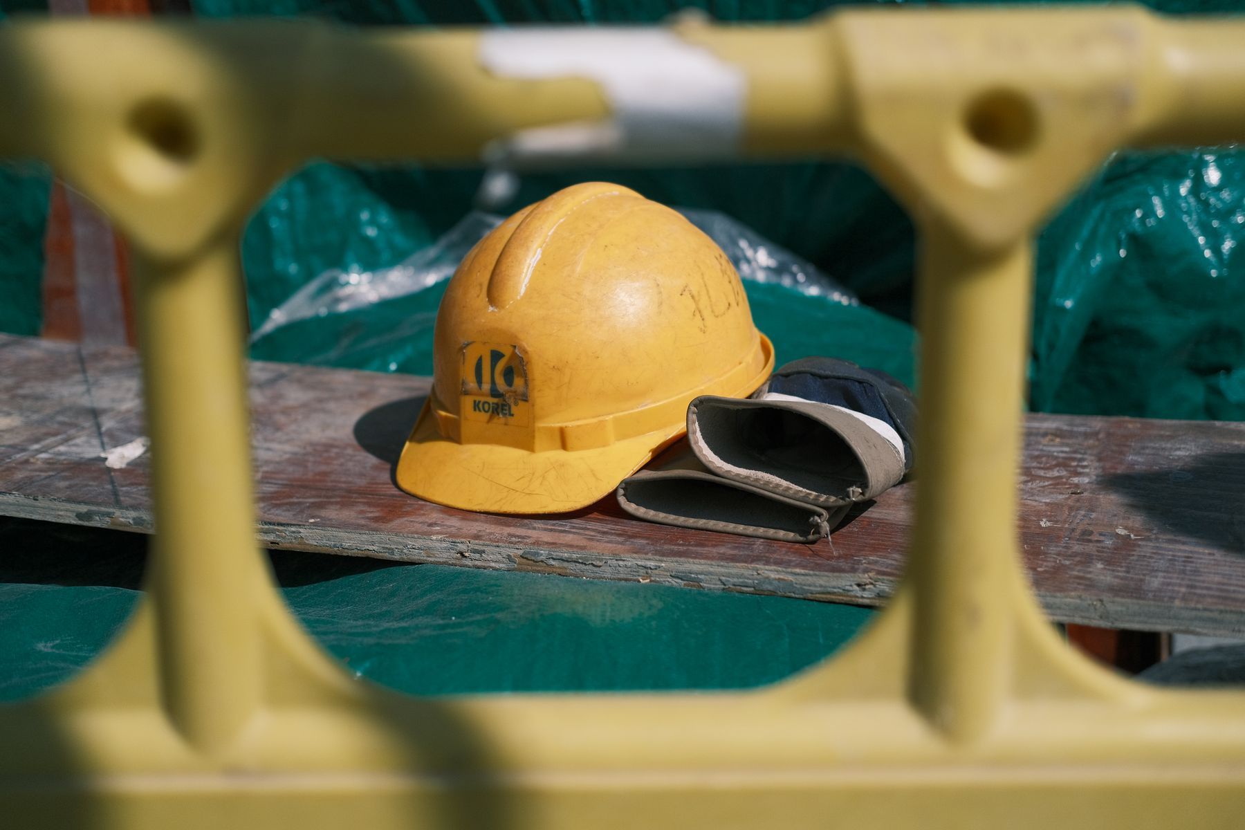 Yellow hard hat resting on a steel beam