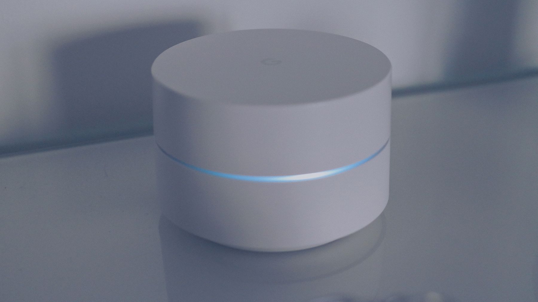 White wireless access point with a blue status ring